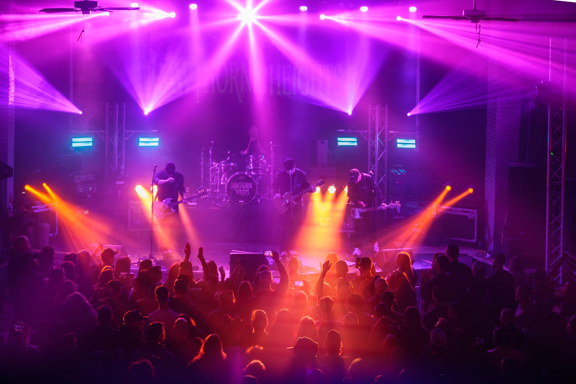 Hawthorne Heights on stage at The Rex Theatre, magenta and amber beams over a sold-out floor